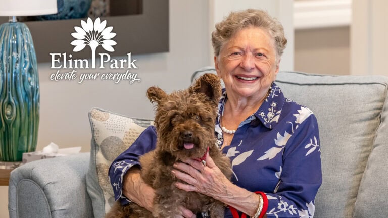 Barbara with her dog Finnegan in her apartment at Elim Park.