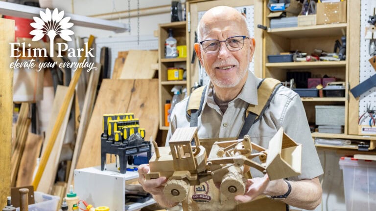 Elim Park resident Clay building a handcrafted wooden model in the community woodshop.